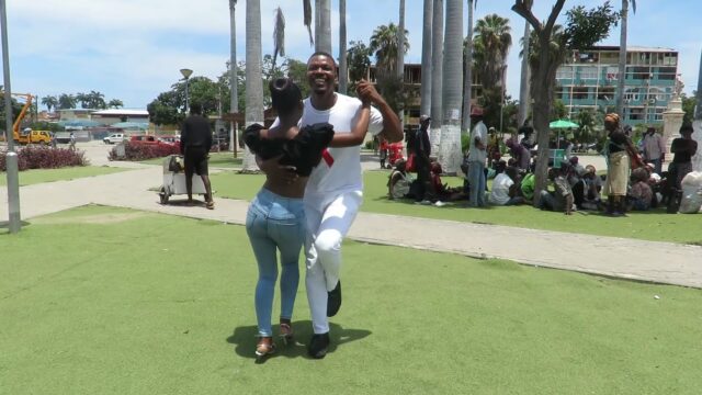 Black Angolan couple dancing Semba Kizomba on the green grass