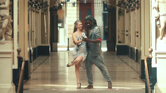 Black man and while woman dancing tango and kizomba on the street