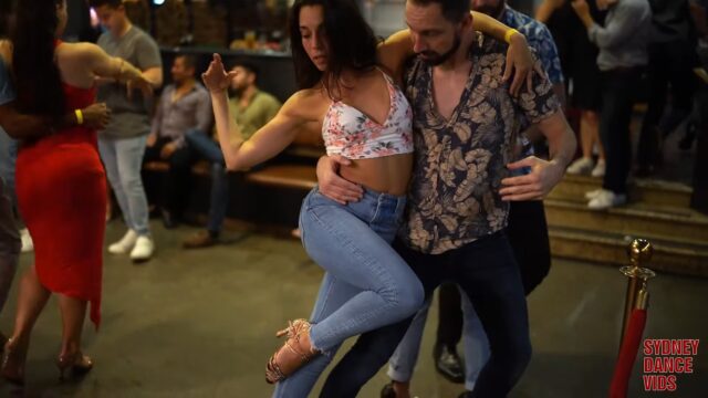 Man and woman dancing together in casual clothes in a club on a social dance event