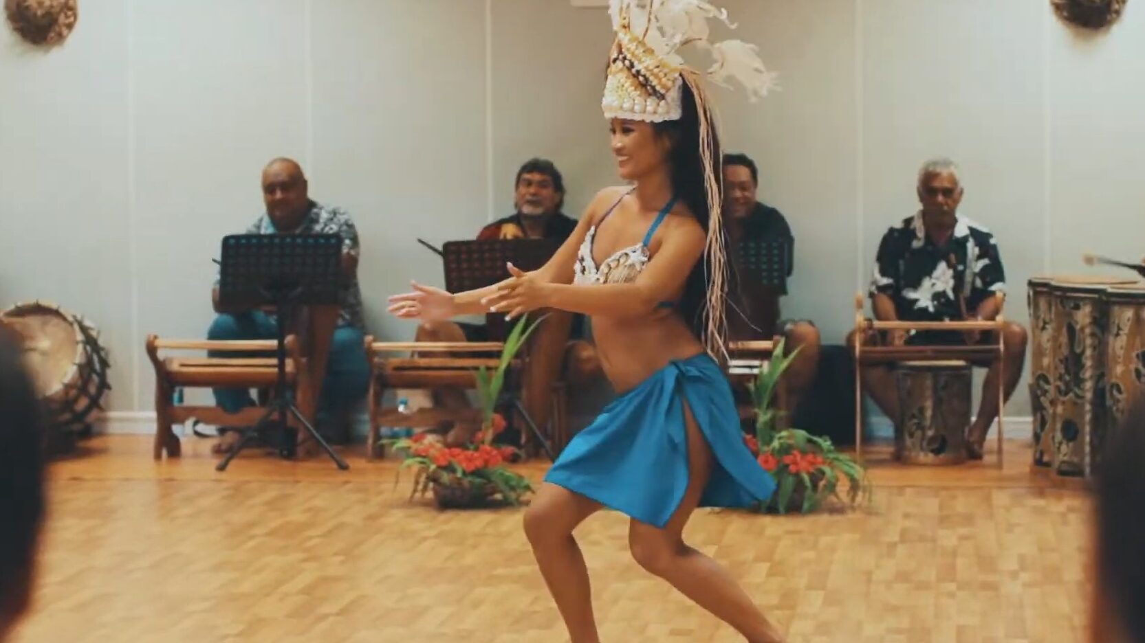 Tahitian woman dancing ori tahiti to live drums in the class room
