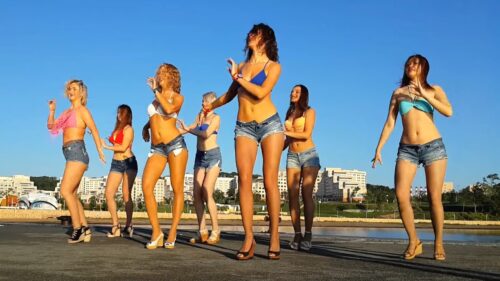 Women in short jeans shorts and bikini tops dancing brazilian samba